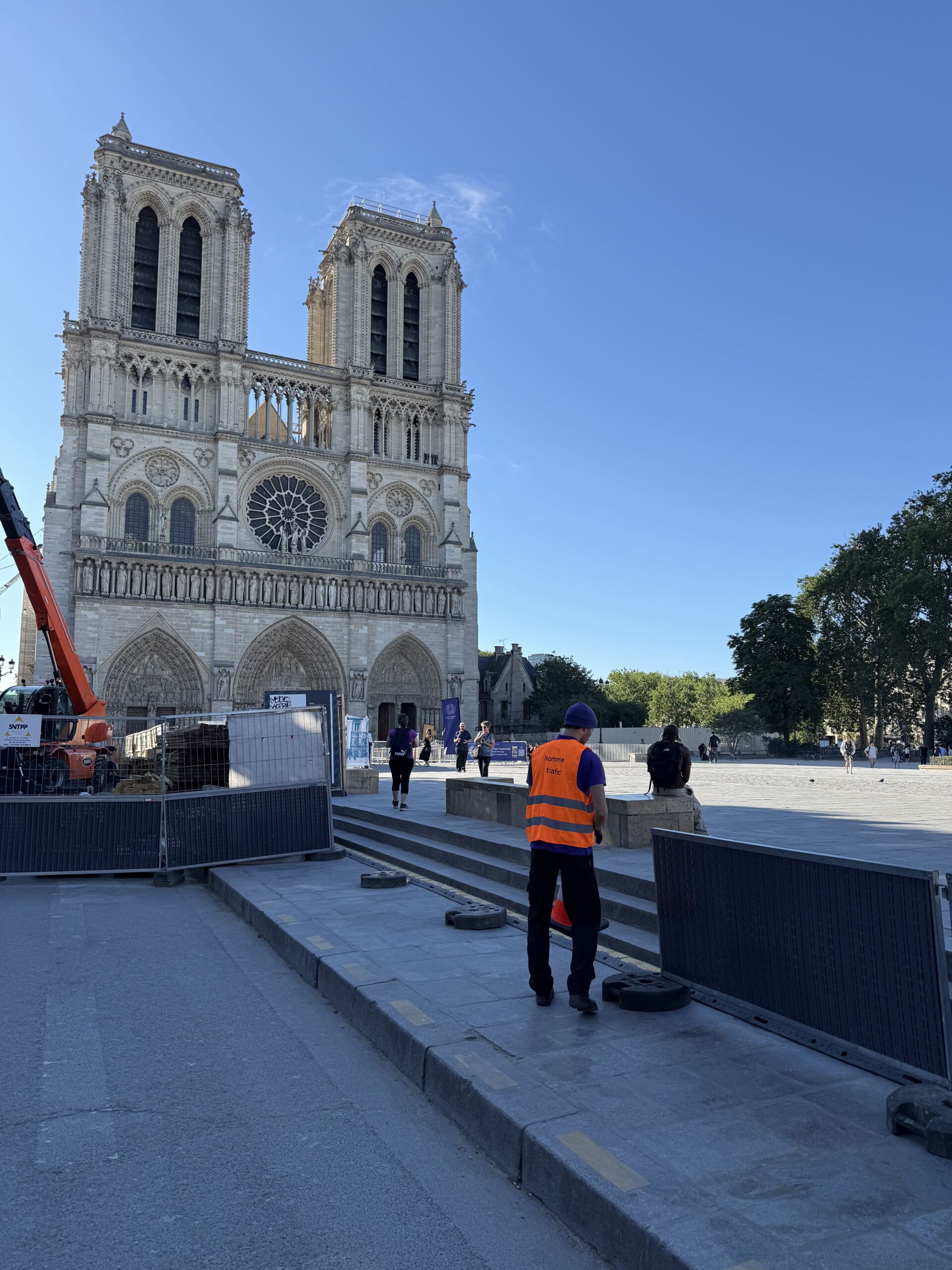 Équipe Mojo Signal installant les barrières de chantier devant Notre-Dame de Paris